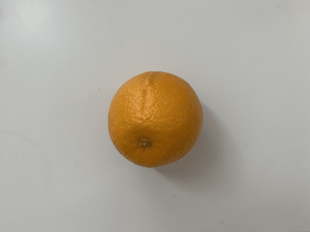 <b>Orange Front</b><br> I used my phone to capture the front of the orange, showing its complete spherical shape and natural color. I chose this object because it is a simple sphere with an uneven surface texture.