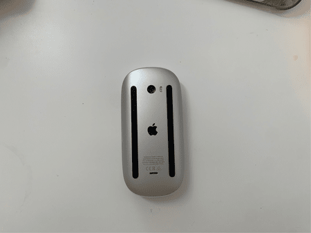 <b>Magic Mouse Back</b><br> I photographed the back of the mouse with my phone, showing functional details such as the glide pads and charging port. I chose this object because it is a complex item with a streamlined design.