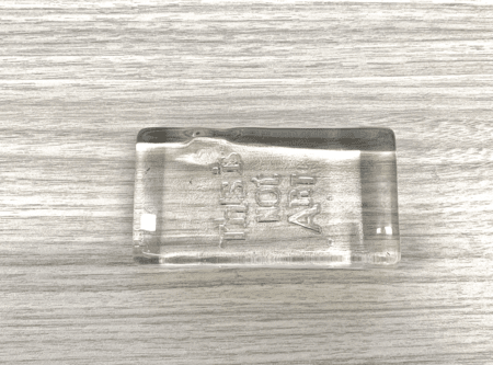 <b>Glass Block</b><br>This clear glass block features the phrase 'THIS IS NOT ART'etched into its surface, showcasing the material's transparency and smooth finish. The reflective quality of the glass creates interesting light interactions, enhancing the visual appeal. Its minimalist design allows the focus to remain on the message.