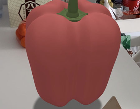 <b>Viewing the Model on My Dining Table with AR</b><br>
          In this image, I used the AR QR code to place the bell pepper model in real life. I tried setting it on my dining table to see how it would look in an actual setting. The AR display makes the model appear as if it’s really sitting on the table.