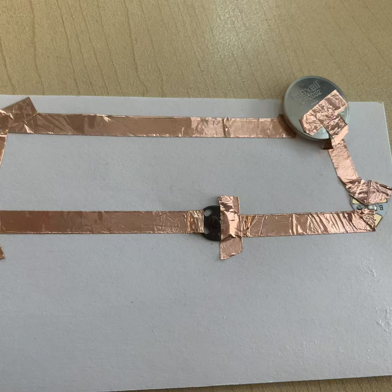 I built the circuit using copper tape, a coin battery, and an LED. The materials were carefully connected according to my diagram.