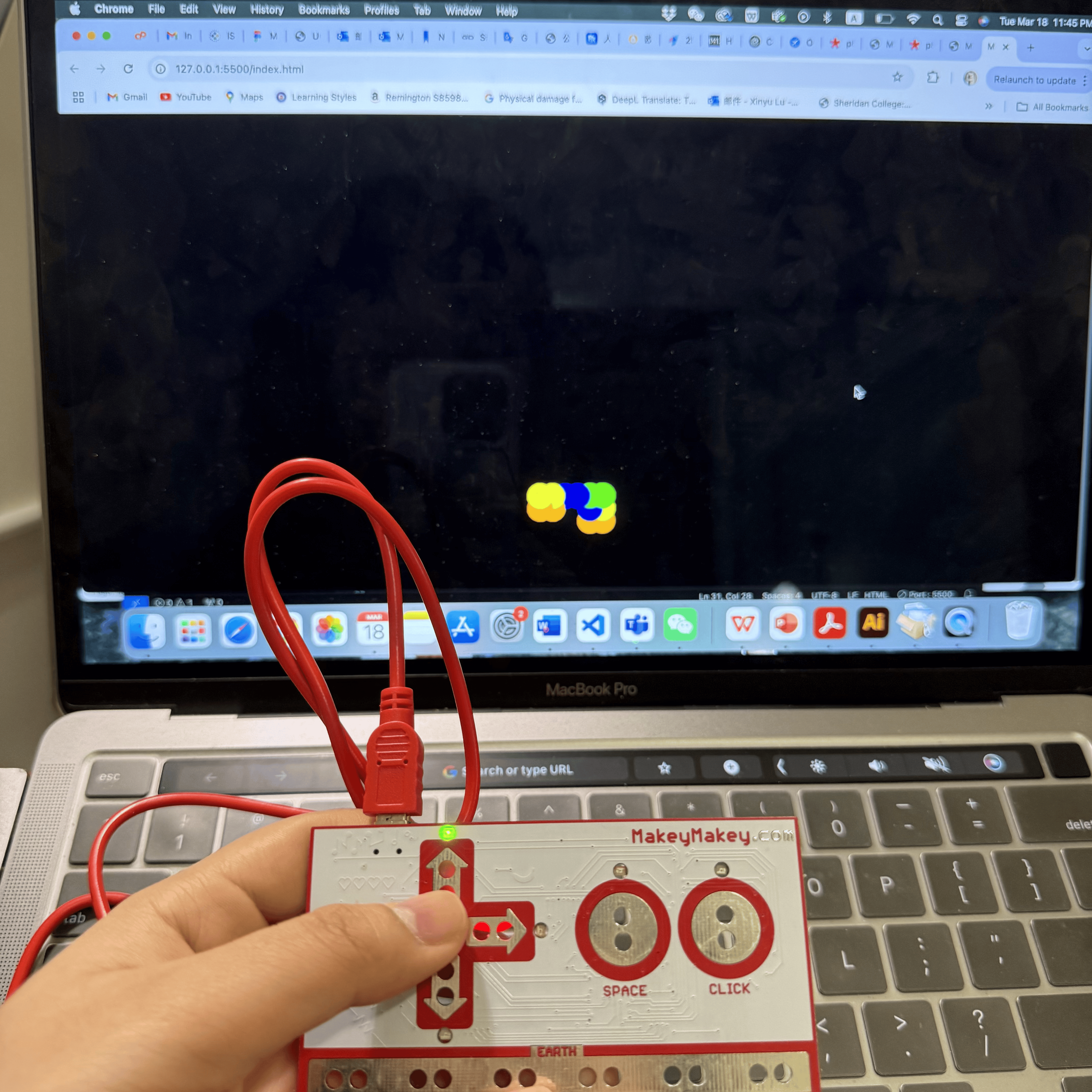 In this photo, I'm interacting with a basic animation displayed on my laptop screen. The animation shows an ellipse that changes colors and moves across the screen based on my key presses, creating a playful and dynamic visual.